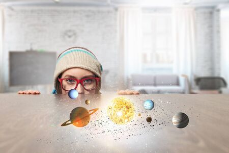 Hipster girl looking from under table. Mixed mediaの写真素材