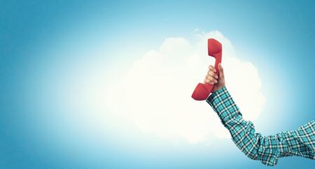 Telephone receiver in hand . Mixed mediaの写真素材