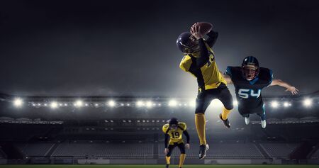 American football players at arena . Mixed media