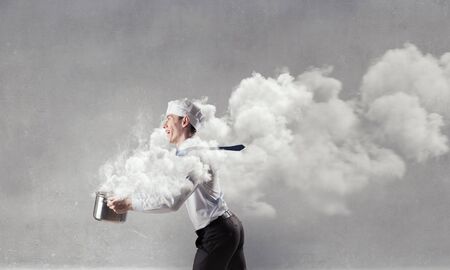 He is cooking something special . Mixed mediaの写真素材