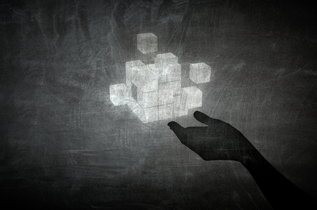 Cube figure in palm . Mixed mediaの写真素材