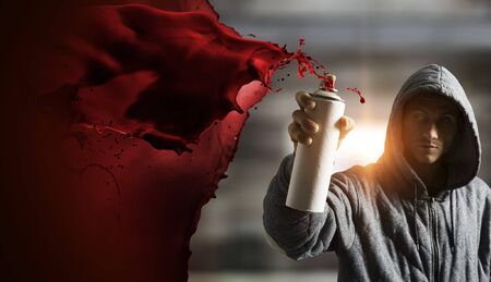 Guy drawing with spray . Mixed mediaの写真素材