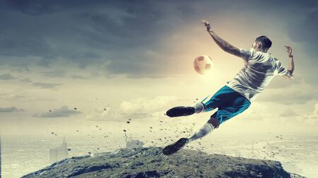 Soccer player kicking ball . Mixed mediaの写真素材