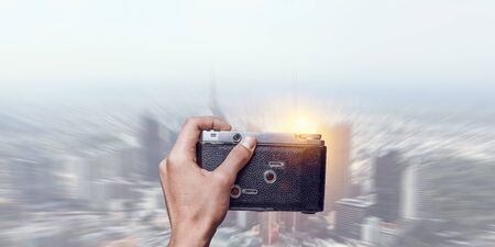 Man taking photo with vintage camera . Mixed mediaの写真素材