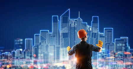 Builder man using media interface . Mixed mediaの写真素材