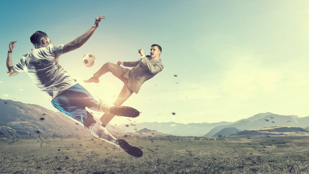 Soccer player kicking ball . Mixed mediaの写真素材