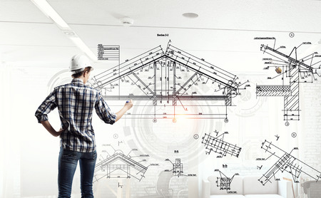 Builder woman sketching project . Mixed mediaの写真素材