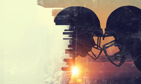 Double exposure of american football players fighting for ballの写真素材
