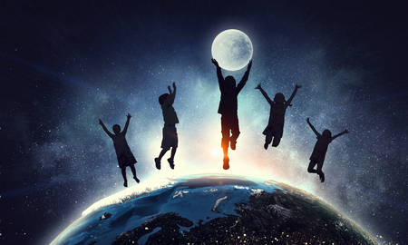 Children silhouette on the night starry background. Elements of this image are furnished by NASAの写真素材