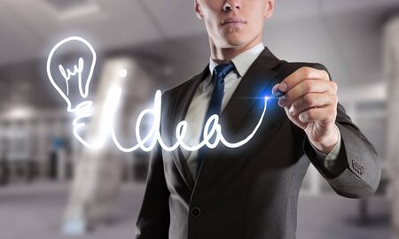 Close up of businessman touching screen with pen. Mixed mediaの写真素材