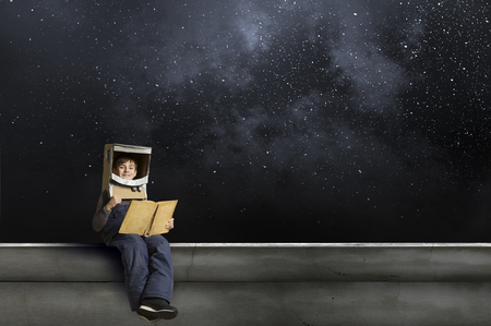 Cute boy in astronaut suit dreaming to explore space. Mixed media . Elements of this image are furnished by NASAの写真素材