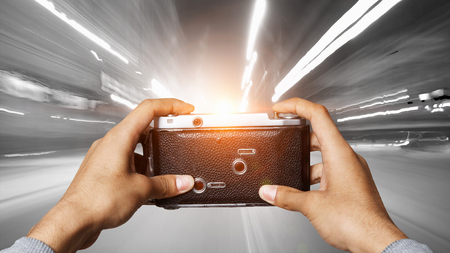 Man with camera in hands . Mixed mediaの写真素材