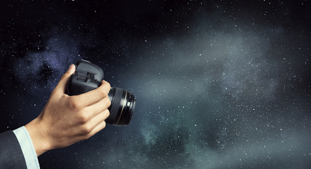 Man with camera in hands . Mixed mediaの写真素材