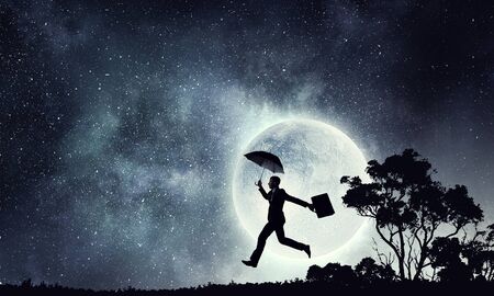 Businessman in night sky . Mixed mediaの写真素材