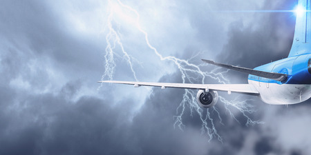 Airplane flying in stormy sky . Mixed media . Mixed mediaの写真素材