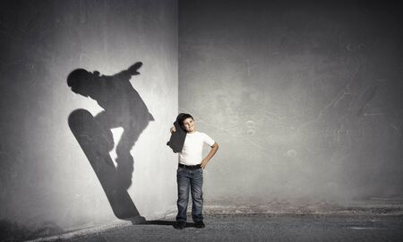 Kid dreaming to ride snowboard . Mixed mediaの写真素材