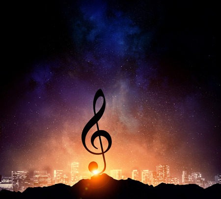 Silhouette of music sign on rock peak against starry sky. Mixed mediaの写真素材