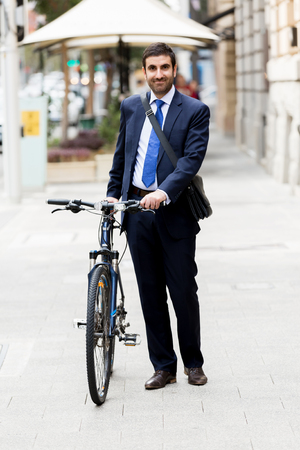 Young businessmen with a bikeの写真素材