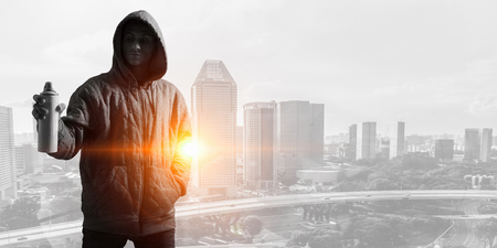 Guy drawing with spray . Mixed mediaの写真素材