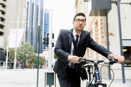 Young businessmen with a bikeの写真素材