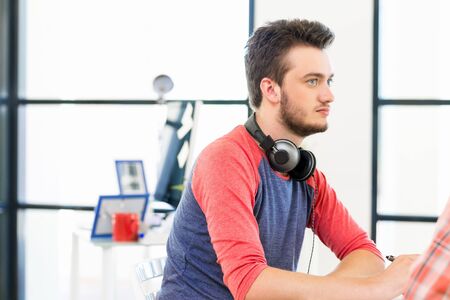 Young man working in officeの写真素材