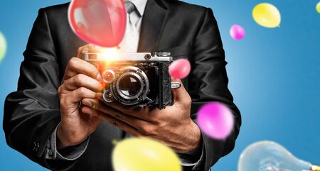 Man with camera in handsの写真素材