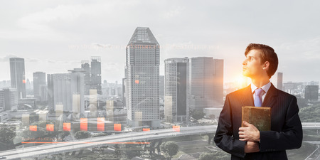 Businessman with old bookの写真素材