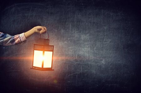 Hand holding lantern . Mixed mediaの写真素材