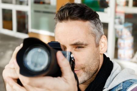 Male photographer taking pictureの写真素材