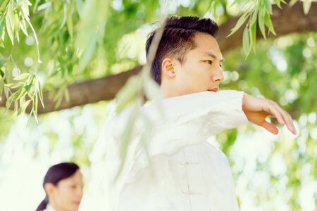 Handsome man practicing thai chiの写真素材