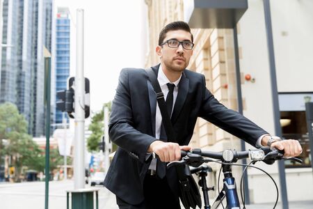 Young businessmen with a bikeの写真素材