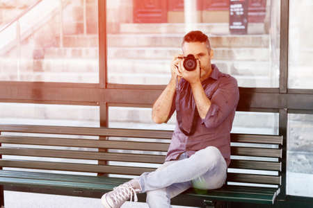 Male photographer taking pictureの写真素材