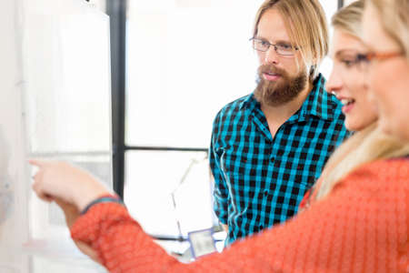 Young office workers discussingの写真素材