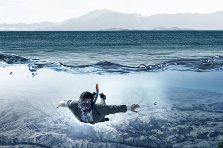 Diving in water businessman . Mixed media . Mixed mediaの写真素材