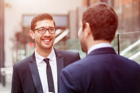 Two businessmen talking outdoorsの写真素材