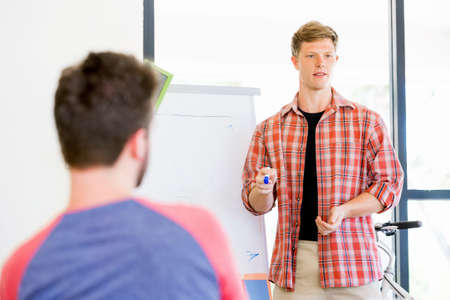 Casual businessman giving a presentation in the office