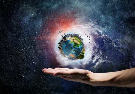 Human hand holding in palm Earth planet. Elements of this image are furnished by NASAの写真素材
