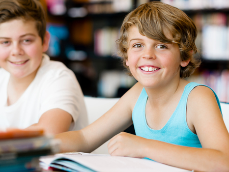 Two boys in libraryの写真素材