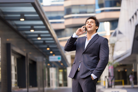 Portrait of confident businessman with mobile phone outdoorsの写真素材