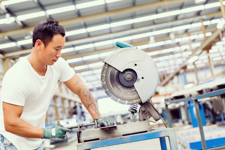 Asian worker in production plant on the factory floorの写真素材