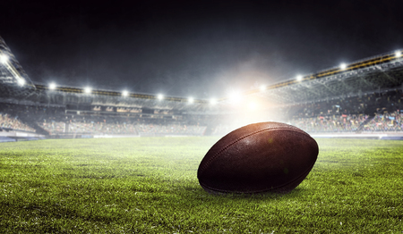 Pro American football field and ball on green grass. Mixed mediaの写真素材