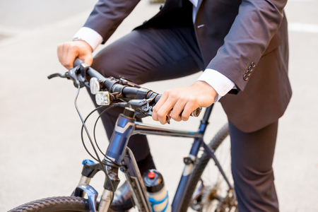 Successful businessman riding bicycleの写真素材