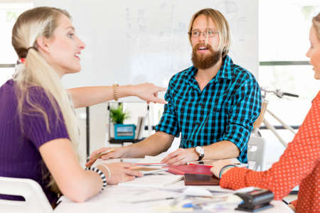 Young office workers discussing