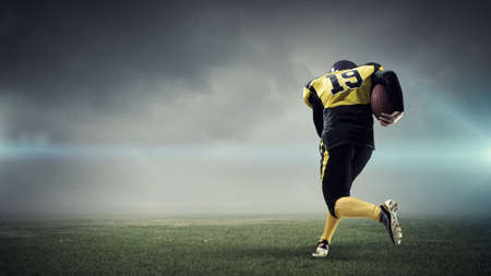 Center player running with ball in hands. Mixed mediaの写真素材