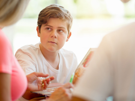 Boy in libraryの写真素材