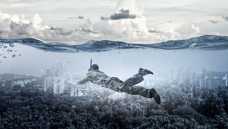 Diving in water businessman . Mixed mediaの写真素材