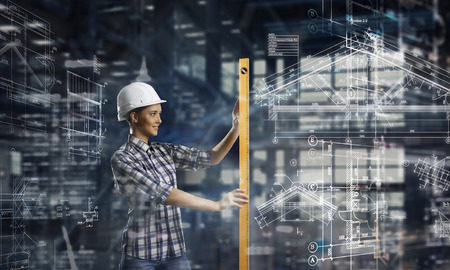 Builder woman taking measuresの写真素材