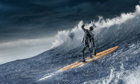Surfing big waves. Mixed mediaの写真素材
