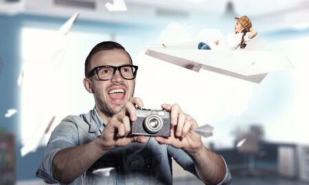 Guy with retro photocamera. Mixed mediaの写真素材