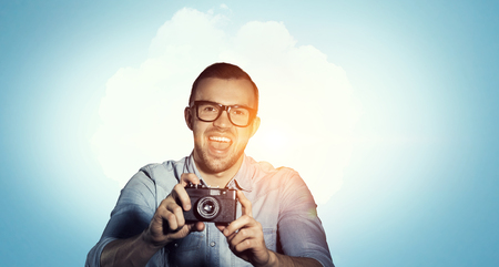 Guy with retro photocamera. Mixed mediaの写真素材